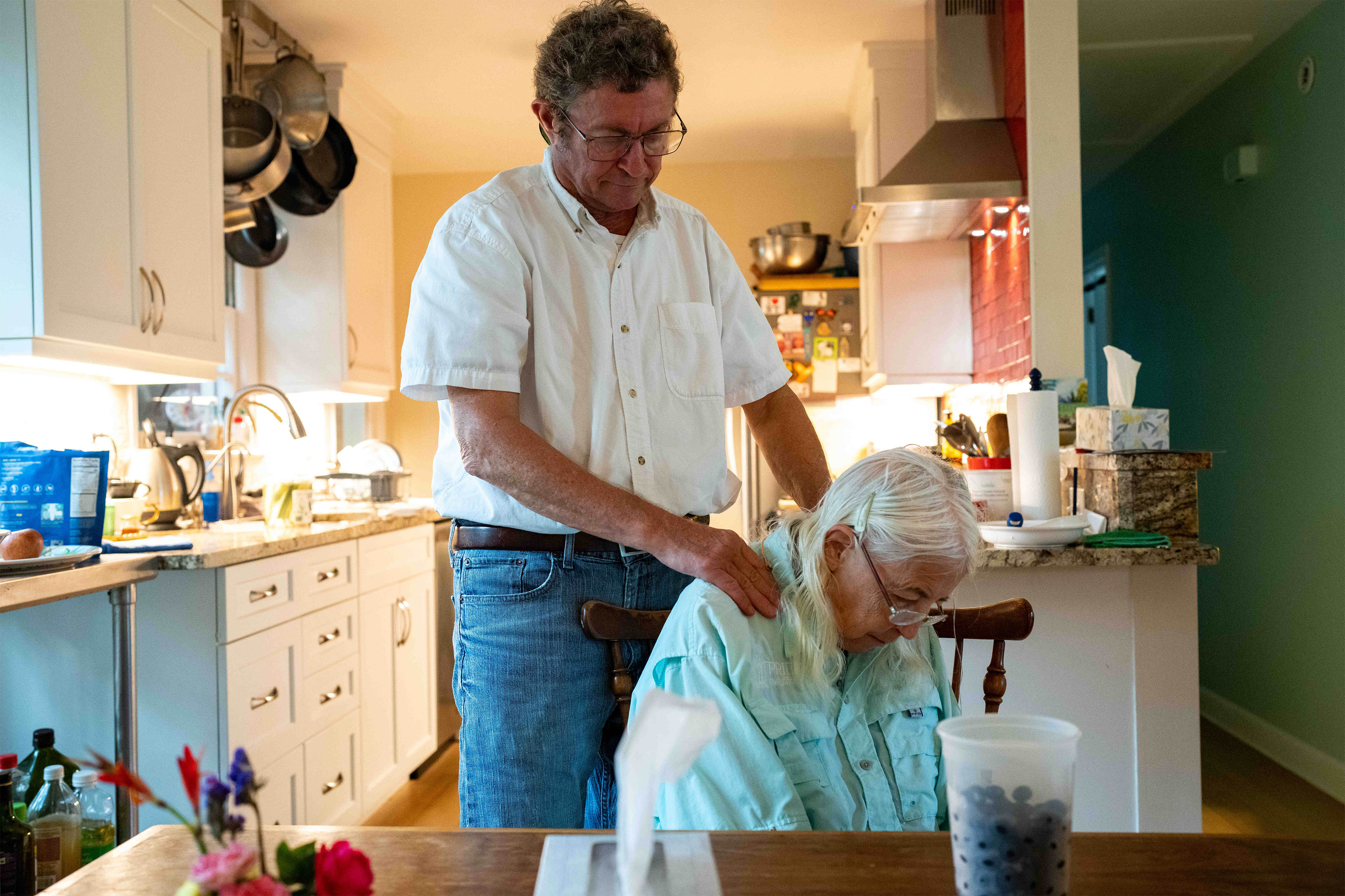 A photo of a man rubbing his wife's shoulders.