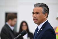 A photo of Rob Bonta speaking outside in front of a microphone.