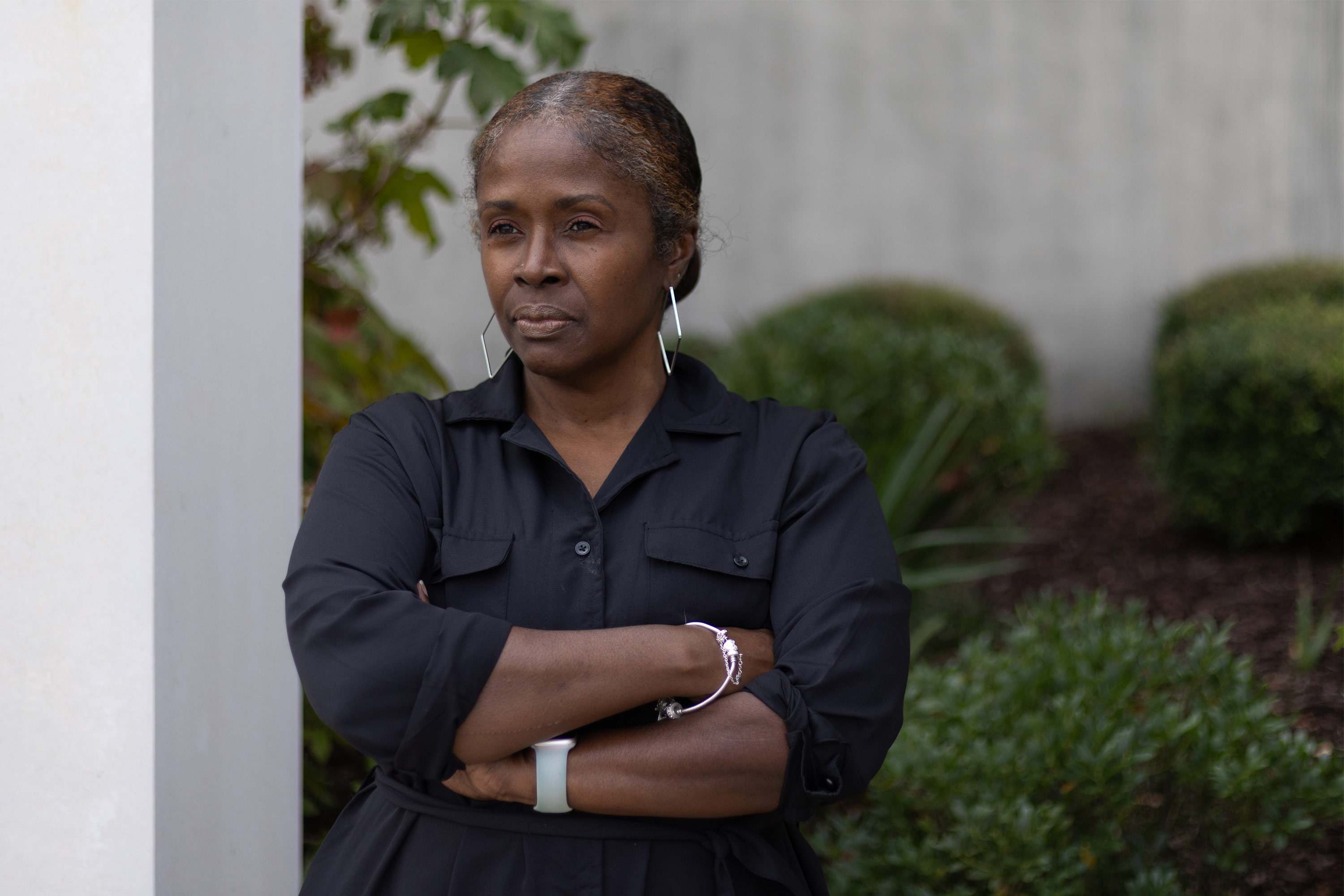 A photo of a Black woman standing with her arms crossed outside. She is Amari Marsh's lawyer.